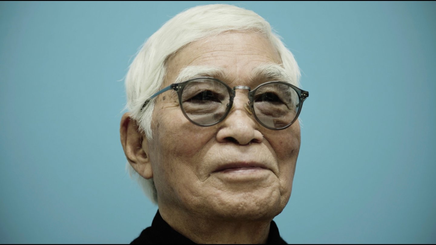 Filmstill of Masao Adachi Takes a Passport Photo